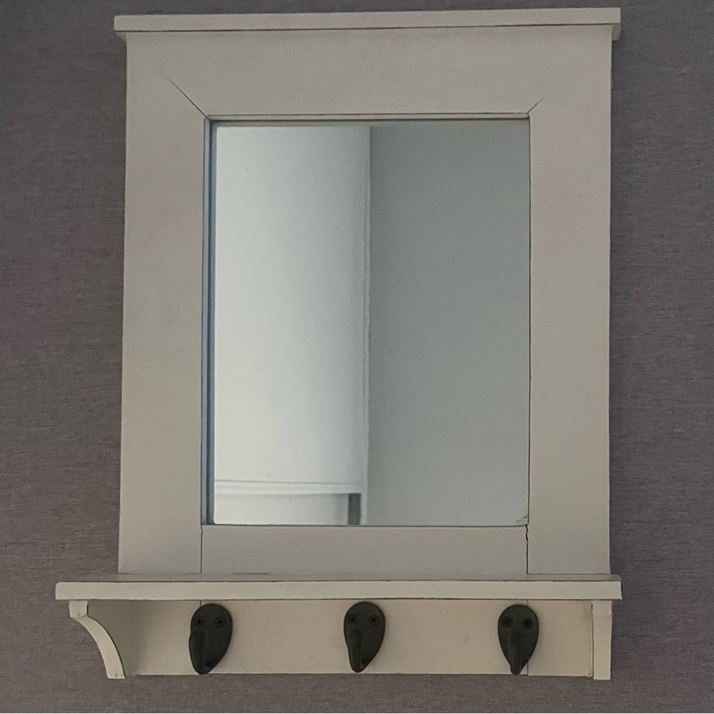 white mirror and coat hanger